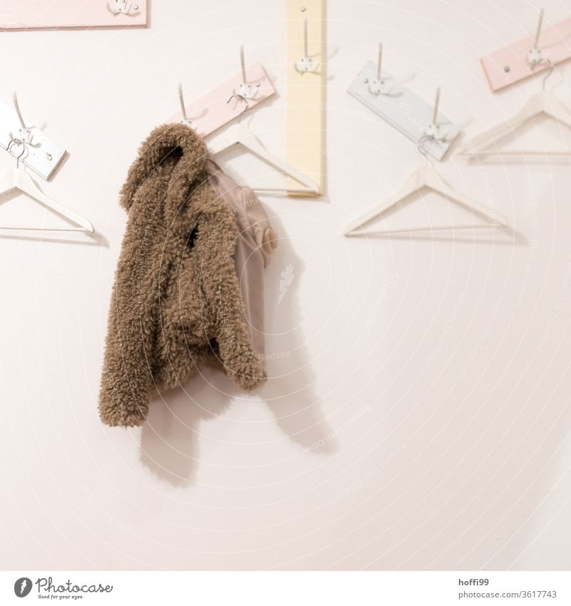 the forgotten jacket at the empty wardrobe Jacket Clothes peg Plush plush jacket Wall (building) Checkmark hang Arrangement coat hook Receive