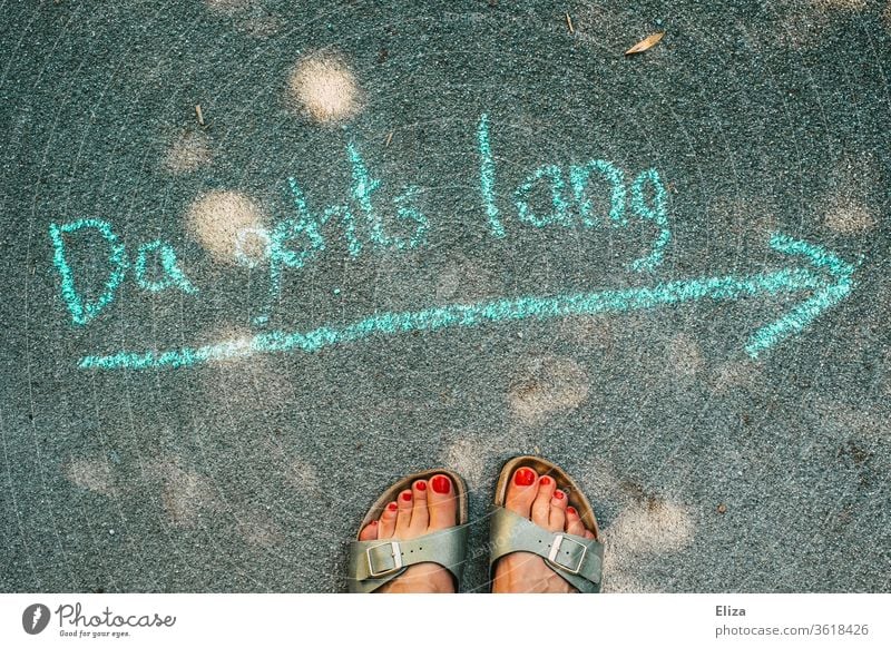 Directional arrow with chalk painted on the road and female feet Arrow Road marking Paperchase Lanes & trails Orientation Street groundbreaking off