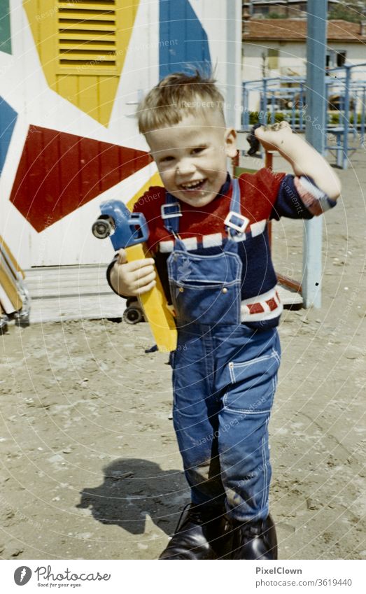 A little boy plays on the beach during the summer holidays Boy (child) Child portrait Laughter Playing Happiness vacation Summer vacation Beach Infancy