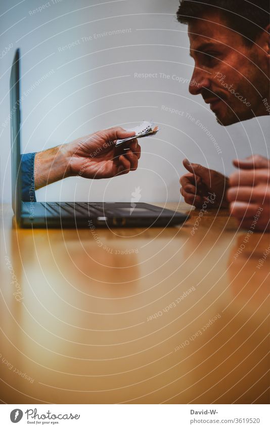 Man sits in front of the computer and watches a hand with money coming out of the laptop. by hand Money Computer Offer Euro Bank note labour Display Fraud