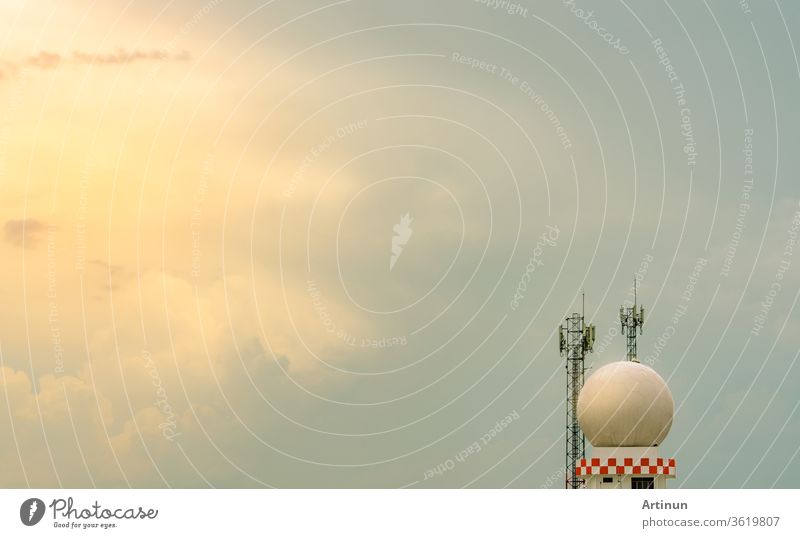 Weather observations radar dome station and telecommunication tower against blue sky and clouds. Aeronautical meteorological observations station tower use for safety aircraft in aviation business.