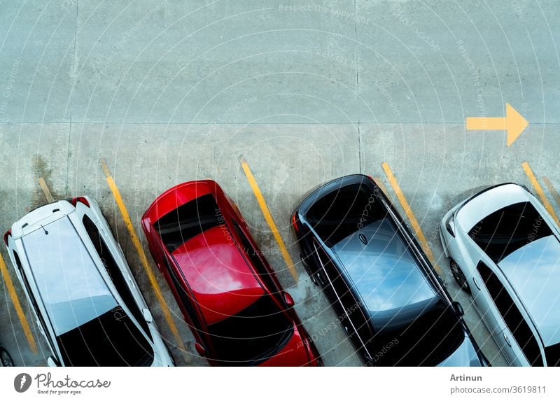 Top view of car parked at concrete car parking lot with yellow line of traffic sign on the street. Above view of car in a row at parking space. No available parking slot. Outside car parking area.