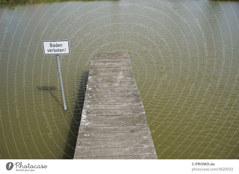 Bathing lake with jetty and sign "Bathing prohibited" II Footbridge Swimming lake bathing prohibited Lake Summer Water Prohibition sign