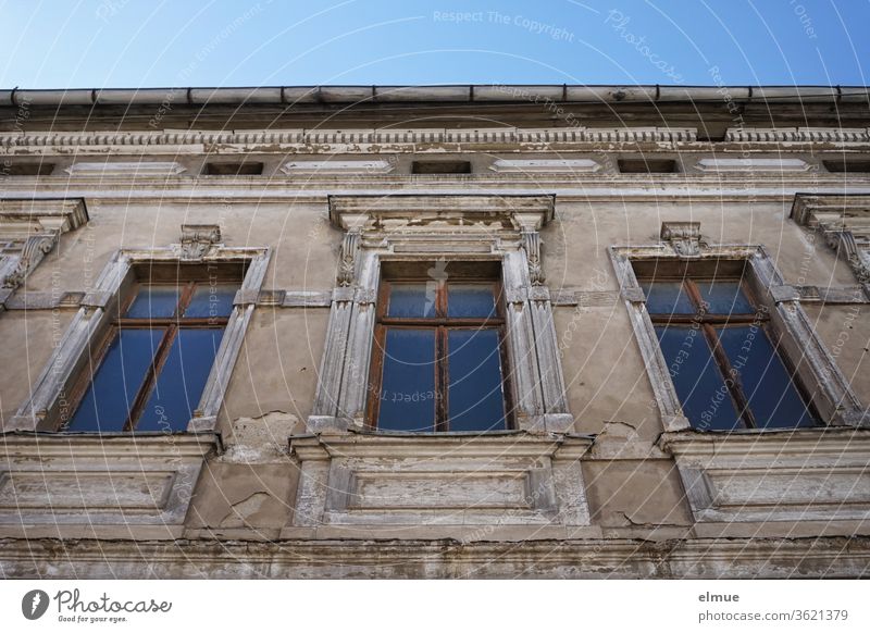 Partial view of a dilapidated building from the Wilhelminian period with three high windows from the frog's perspective old building Window Worm's-eye view