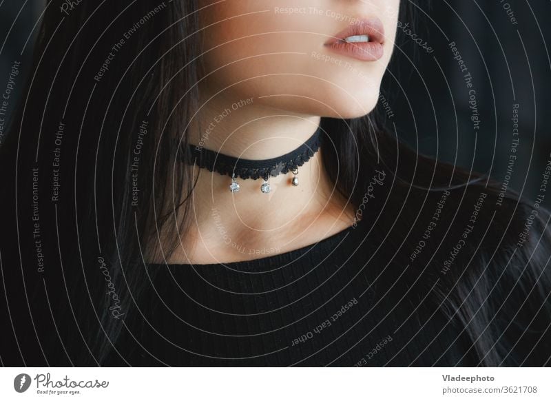 Close up of stylish black choker on female neck beauty model style necklace woman fashion young beautiful modern person skin background girl glamour jewelry