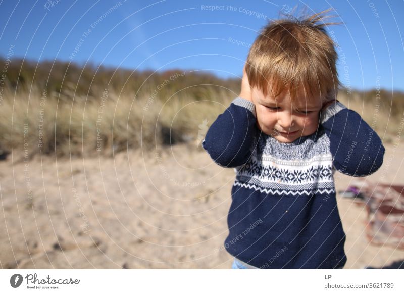 Little boy hlding his hands on the ears refusal Against Exterior shot hearing Hearing impairment Hearing protection Hearing aid Denial Sense of hearing