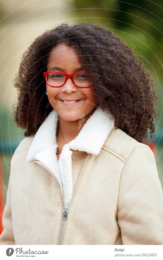 African girl with a beautiful hair in a park child ten african american pretty kid school portrait face diversity young afro beauty preteen sky mixed curly