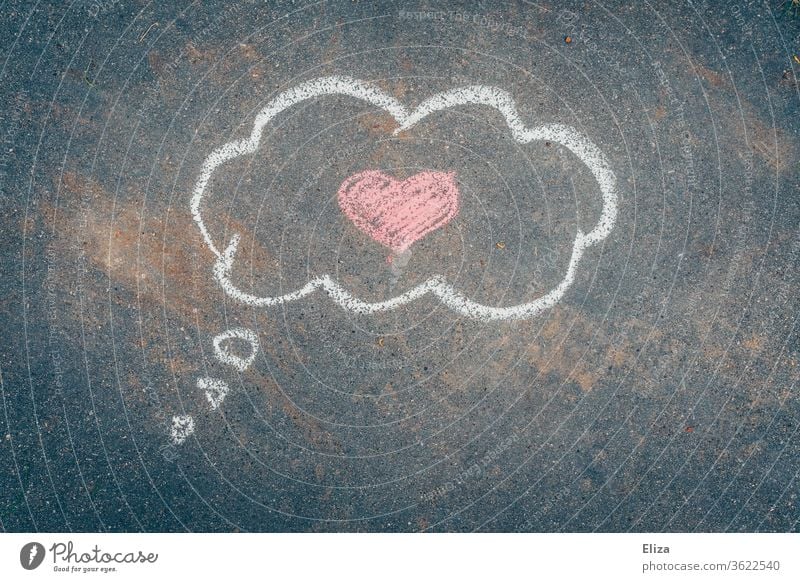 Love in the head. Chalk painted thought cloud with a pink heart in it on asphalt. Valentine's Day. In love Thought Cloud romantic Heart Romance Emotions