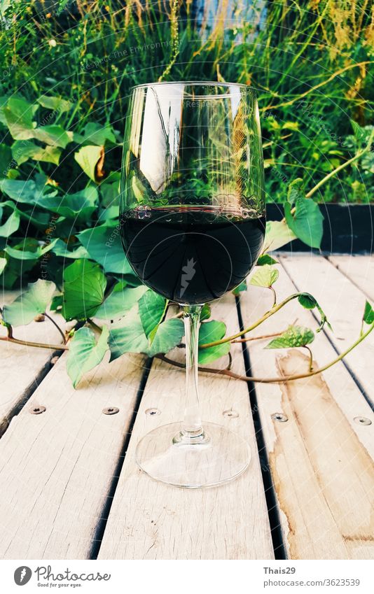 glass of red wine on wooden background outdoor garden alcohol alcoholic bar barrel beverage bottle celebration closeup culture drink food grape italian leaf