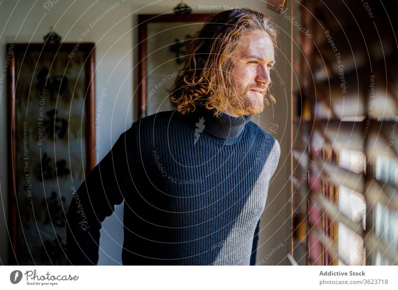 Mature man looking out window home enjoy weekend mature calm peaceful street observe male casual rest chill relax harmony cozy tranquil serene serious