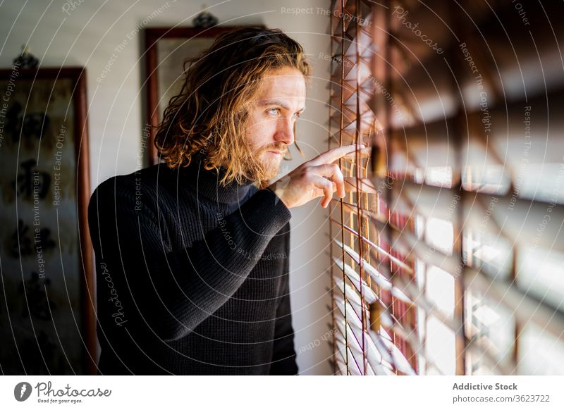 Mature man looking out window home enjoy weekend mature calm peaceful street observe male casual rest chill relax harmony cozy tranquil serene serious