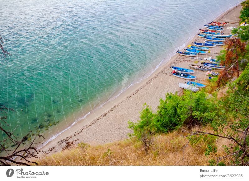 Small angling boats are dry docked on the beach Above Along Angling Ashore Bay Beach Below Boat Calm Cliff Coast Coastline Cove Docked Dry Edge Fishing Boat