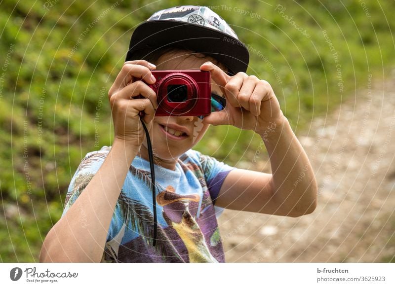 Child with camera takes a photo stop Exterior shot Infancy 8 - 13 years Looking into the camera Boy (child) portrait Take a photo