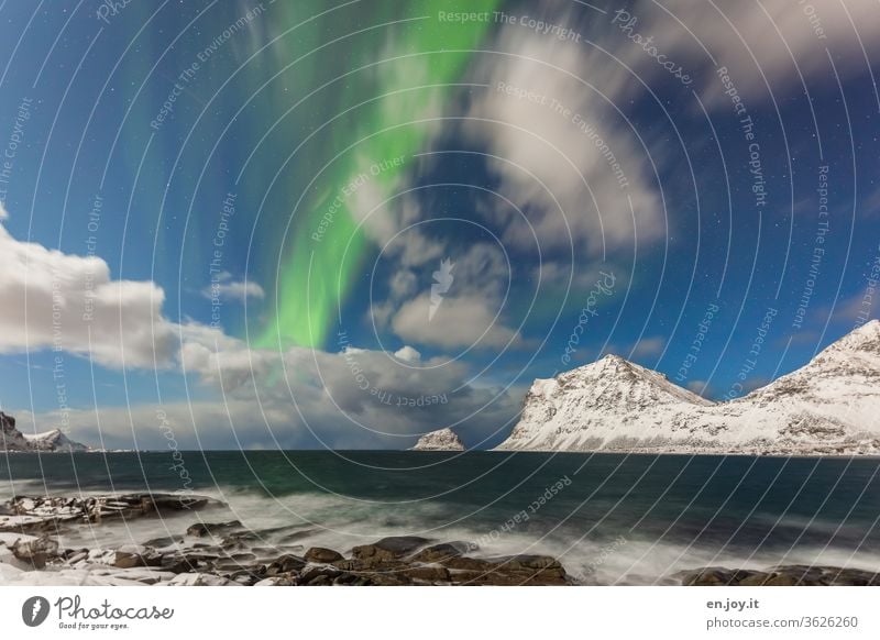 Northern lights in Haukland northern lights Clouds Lofotes Norway Haukland Beach mountains Snow Winter Ocean Coast Rock Night sky Long exposure Scandinavia