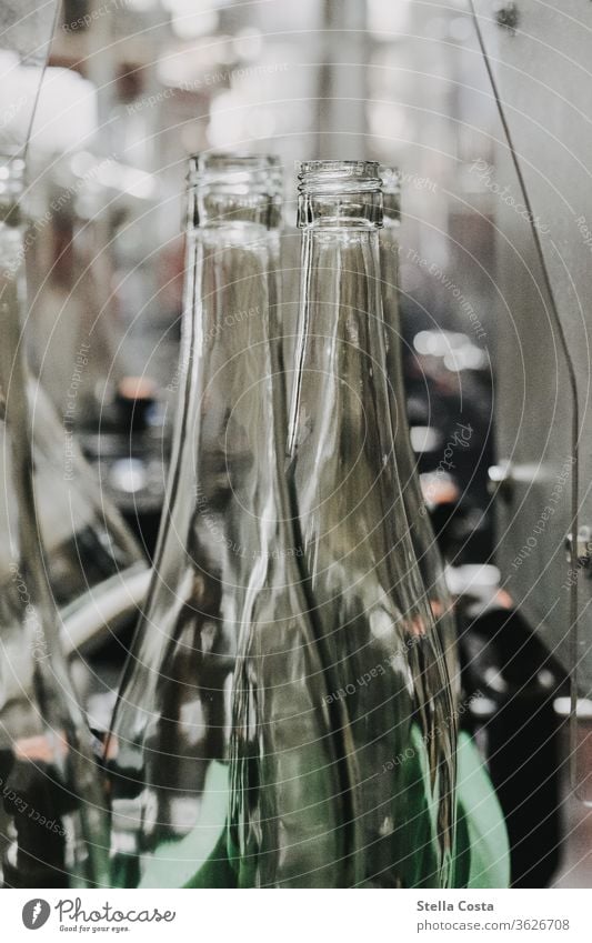 Empty wine bottles run into the wine bottling machine Interior shot Vine Winegrower Deserted Alcoholic drinks Colour photo Shallow depth of field Detail