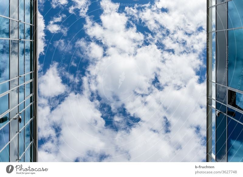 Modern building, glass surfaces, blue sky with clouds Sky Glass reflection Architecture Reflection Facade Manmade structures Exterior shot Window Town built