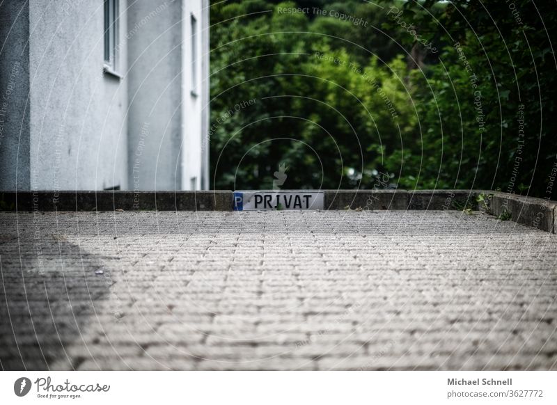 Parking sign with the inscription "Private" on a stone edge Parking lot parking lot marking Signs and labeling Transport Signage Exterior shot Colour photo