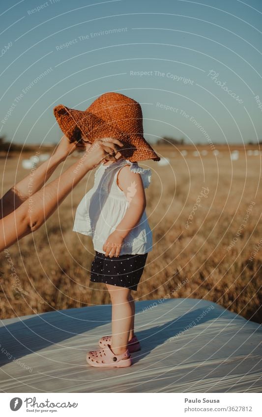 Child with straw hat childhood Childhood memory Infancy Playing Girl Colour photo Hand Parenting Summer Nature 1 - 3 years Leisure and hobbies