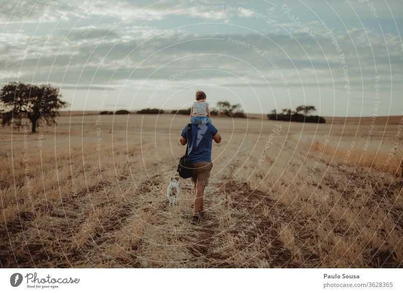 Father with daughter Carrying Shoulder shoulders Walking Family & Relations Father with child Field Summer Summer vacation Travel photography travel Pet Dog Man