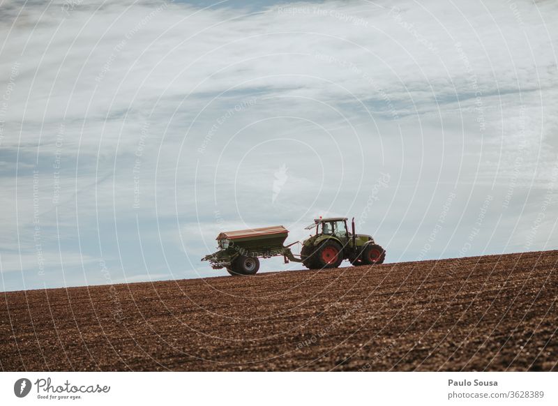 Tractor in fields against the sky Machinery Agriculture Agricultural crop Environment Work and employment Harvest Agricultural machine Day Deserted Forestry