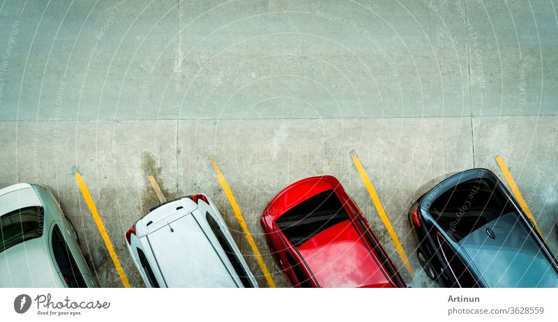 Top view of car parked at concrete car parking lot with yellow line of traffic sign on the street. Above view of car in a row at parking space. No available parking slot. Outside car parking area.