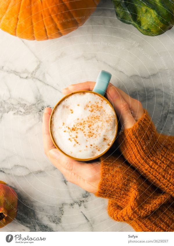 Autumn flat lay with mug of latte coffee autumn hands sweater orange christmas woman food winter marble above light milk moody morning october november pumpkin