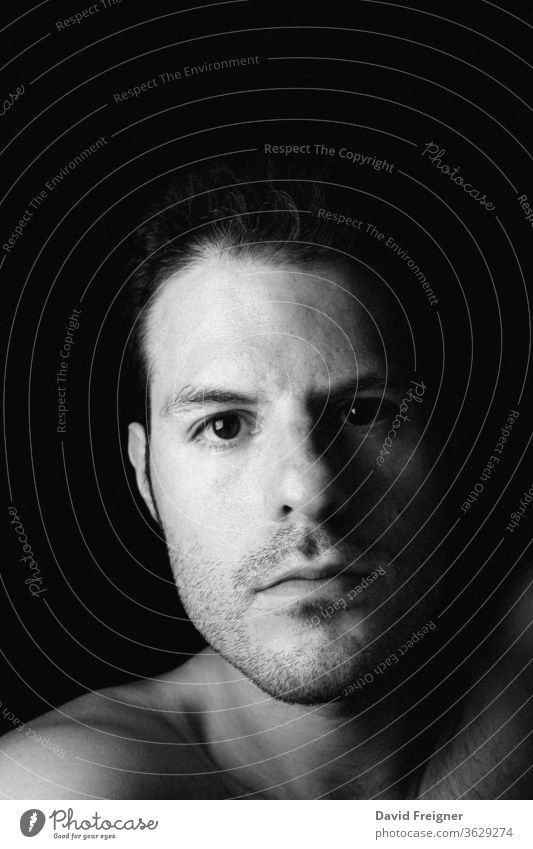 Intimate self portrait of a young man on a dark background human face shadow black background people close-up serious intimate sadness studio shot contemplation