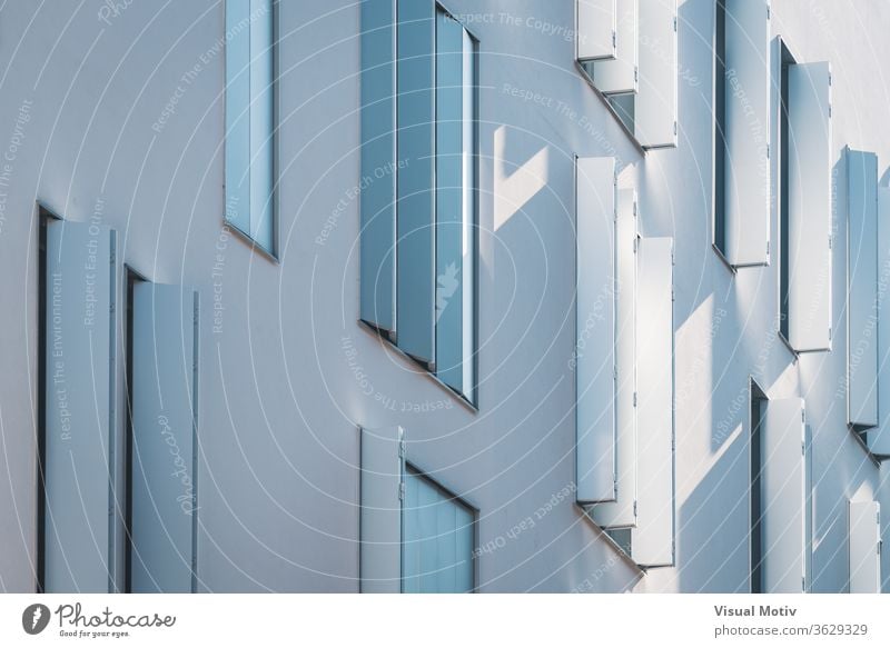 Windows with modern shutters creating light and shadows at the afternoon light building facade windows residential architecture architectural architectonic