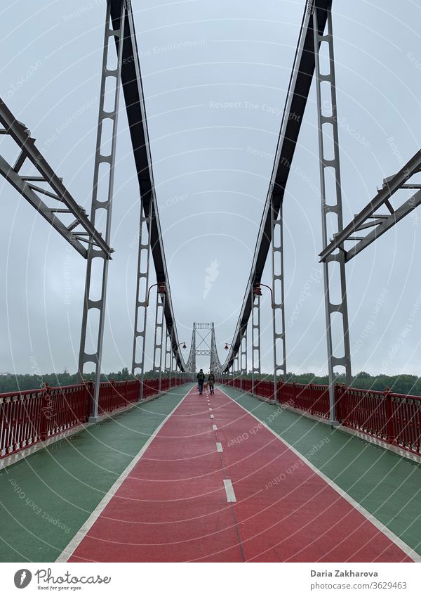 Couple at the bridge couple people city road groomy town friends walking way red architecture travel urban morning cloudy spring