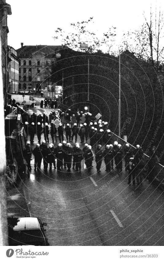 The cops are coming in. Demonstration Provocative Group Police Officer Black & white photo mustered Crowd of people Street wolf montur armed tear gas