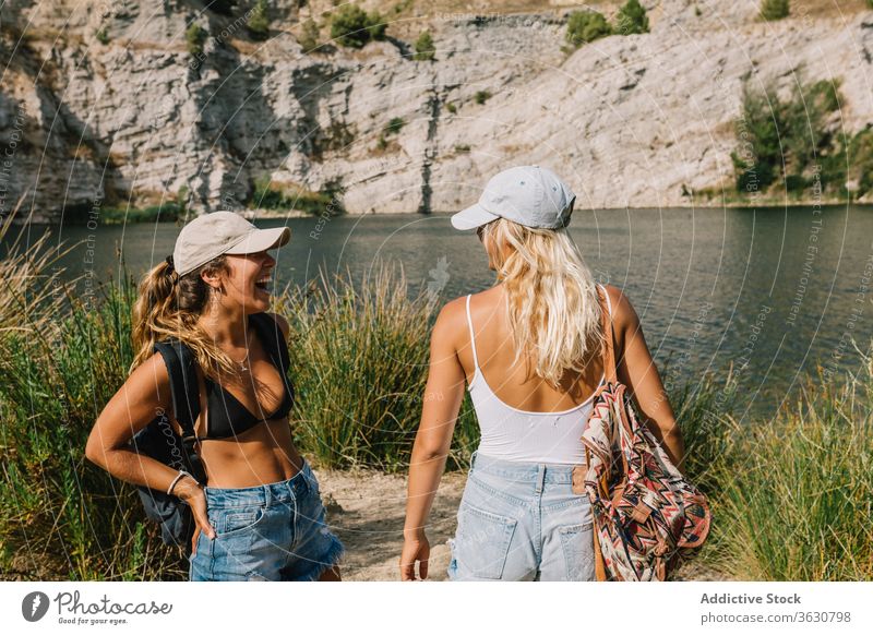 Best female friends near lake during holiday best friend carefree women girlfriend vacation admire landscape spectacular grass shorts stand sunny relax freedom