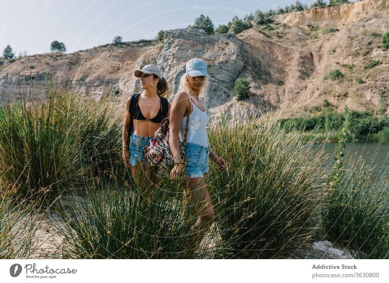 Best female friends near lake during holiday best friend carefree women girlfriend vacation admire landscape spectacular grass shorts stand sunny relax freedom