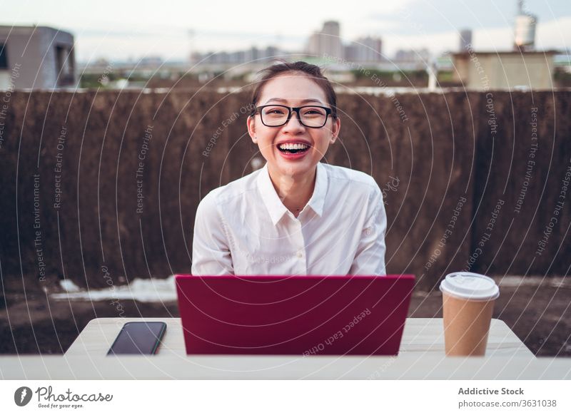 Busy woman with laptop working on rooftop using businesswoman formal device gadget glasses happy asian young female internet communicate browsing connection