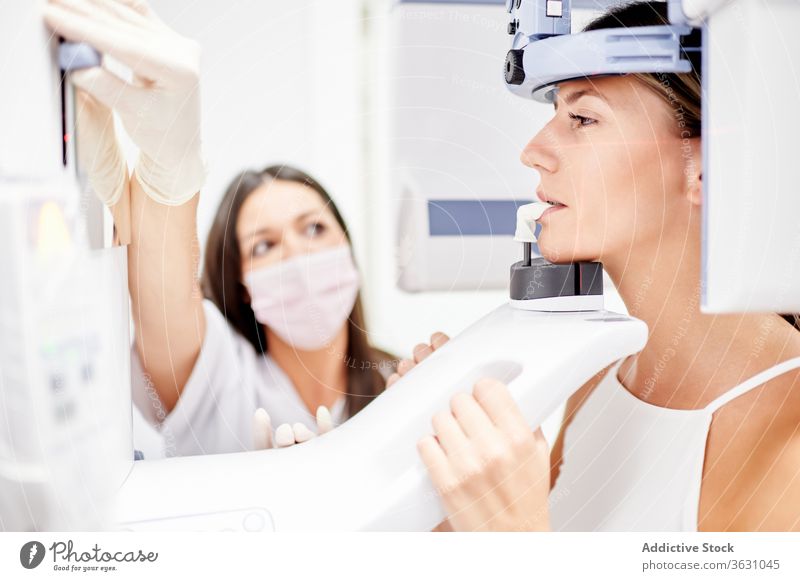 Patient and dentist during X ray procedure women patient x ray clinic scan computer using modern medicine doctor hospital oral contemporary dental professional