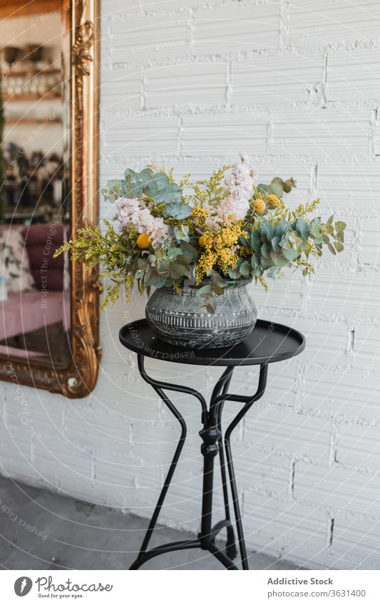 Ceramic vase with colorful flowers on table bouquet floristry fresh natural various pot creative beautiful eucalyptus goldenrod craspedia plant decor design