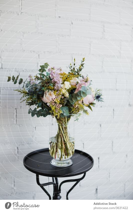 Glass vase with colorful flowers on table bouquet floristry fresh natural various glass pot creative beautiful craspedia plant decor design composition