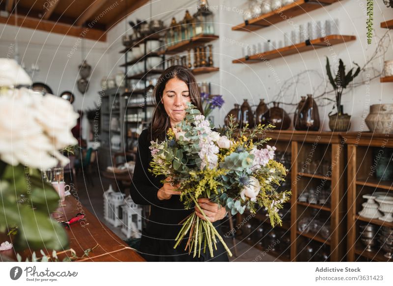 Female designer creating floral bouquets in studio floristry woman arrange create bloom blossom compose decorative female creative work occupation professional