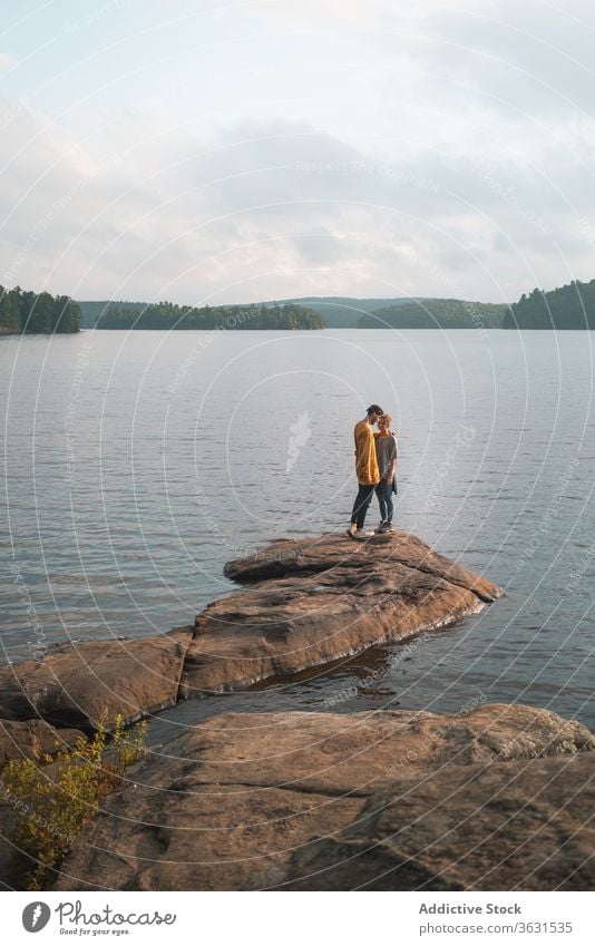 Couple kissing on stone near lake couple scenery tender algonquin provincial park picturesque romantic relationship travel canada together love affection nature