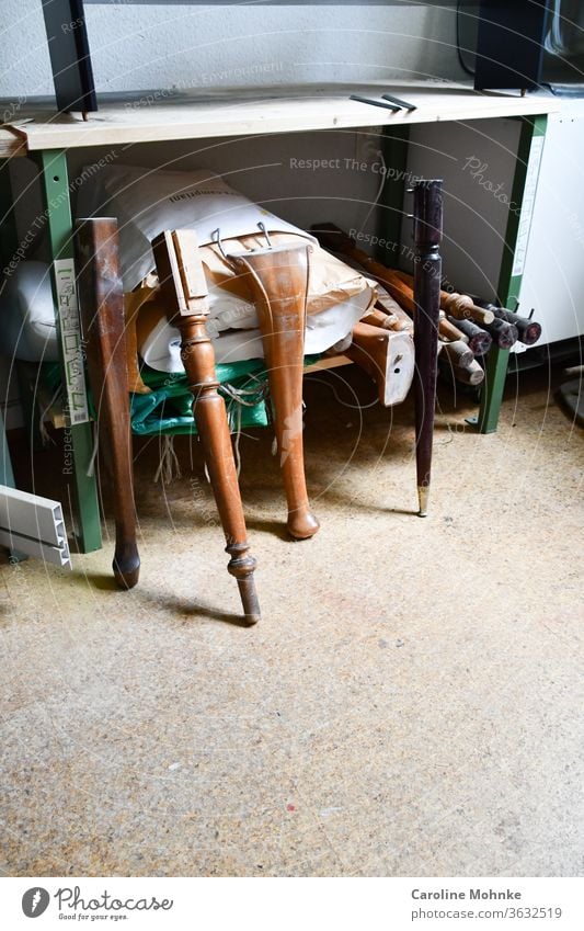 Table legs waiting for their bet table legs wood Colour photo Deserted Furniture Tablecloth Brown Pattern Old Interior shot Detail Light Workshop Floor covering