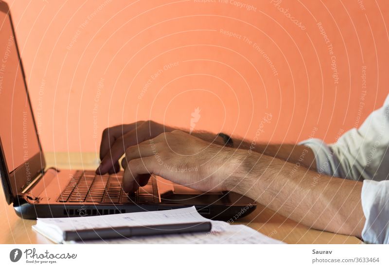 Close up shot of hands of a Young Adult Working from Home on a laptop. work from home staying in working home stay home office millennial young adult