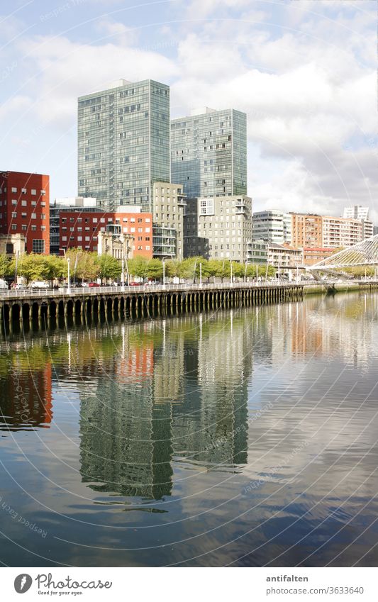 Symmetry | Mirror Worlds II neat clear Reflection in the water Water reflection Clouds Promenade River bank Housefront ria de bilbao Bilbao Town Exterior shot