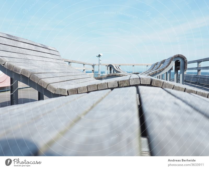 Deckchairs on a pier, selective focus on foreground, vacation or travel concept deckchair bridge wood wooden sea sky beach Baltic Sea water path boardwalk