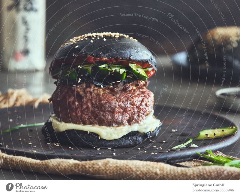 Black Bun Burger Asia Style burger Food & Drinks Fast food feed sb./sth. Meal Cheese Hamburger Cheeseburger Beef Burger Patty Meat selfmade BBQ