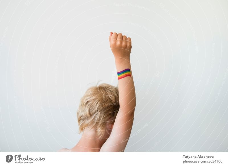 Rised child hand with rainbow LGBTQ pride flag tattoo lgbtq freedom gay lesbian homosexual symbol raised rights colorful bisexual love homosexuality concept