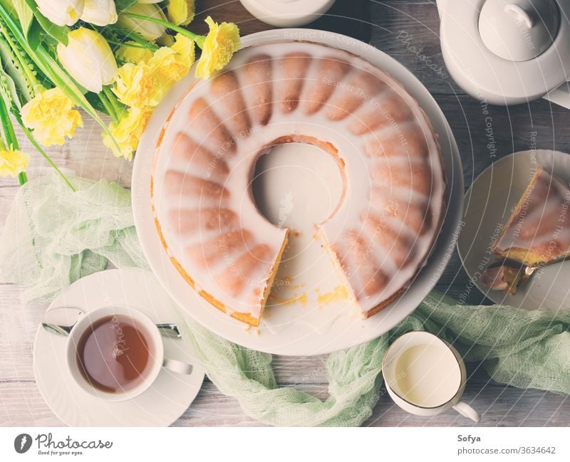 Bundt cake with frosting. Easter festive dessert. Toned bundt spring easter flowers breakfast pastel color yellow green bright food sweet bake bakery holiday