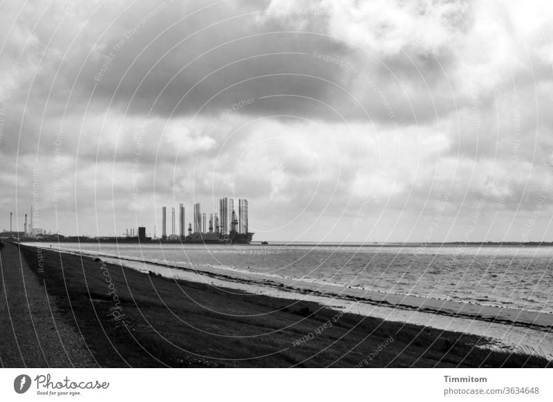 Industrial plants at the North Sea Water Beach Industry spires Clouds Sky Black & white photo Deserted Day Denmark work Environment