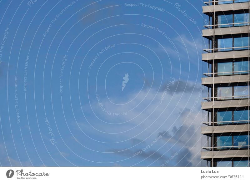 High-rise building facade with lots of blue sky, with thunderclouds and sunshine Facade Glass Window Blue sky Clouds Sky Architecture Modern built