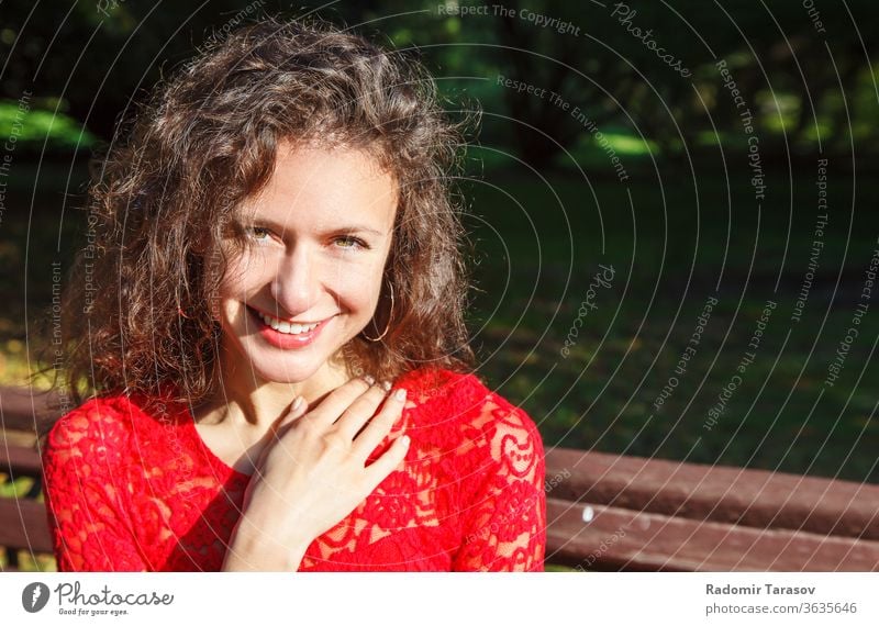 portrait of a young smiling beautiful spanish girl female woman face attractive fashion hispanic people beauty model person hair pretty eye adult happy bench