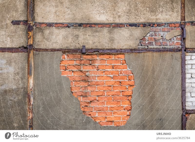 dilapidated facade with chipped plaster, visible truss beams and wall stones | detail view Facade masonry Bricks half-timbered Trussed beams bailer Flaked off