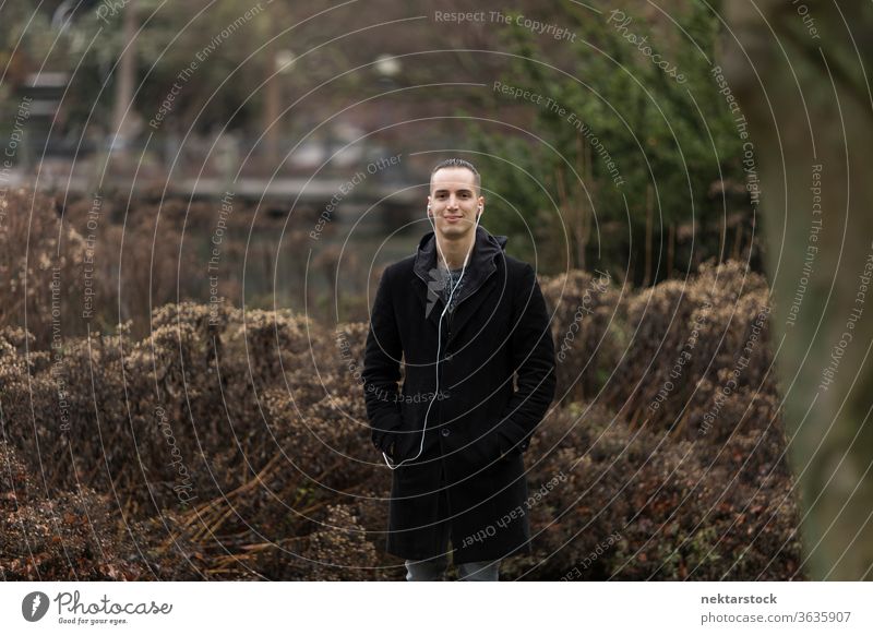 Portrait of Young Man Standing in Park man portrait caucasian ethnicity outdoors natural lighting day fashion 20-30 years old young man 1 person short hair